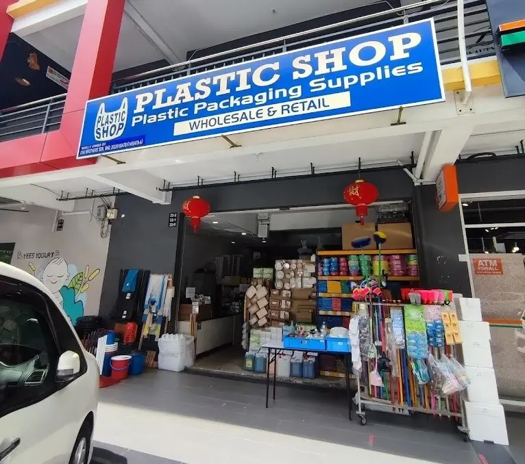 Storefront entrance of plastic shop store featuring packaging supplies with organized shelves and product displays.